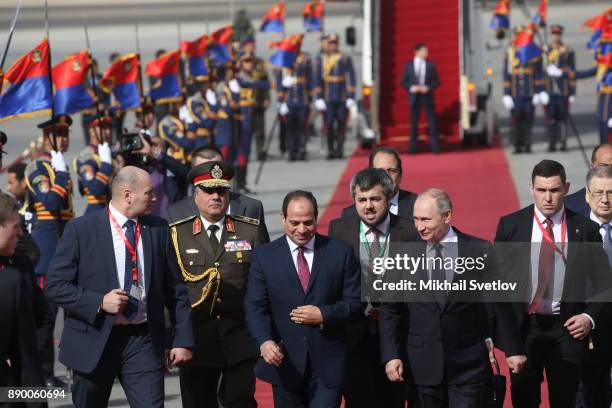 Russian President Vladimir Putin and Egyptian President Abdel Fattah el-Sisi attend a welcoming ceremony at the airport on December 11, 2017 in...