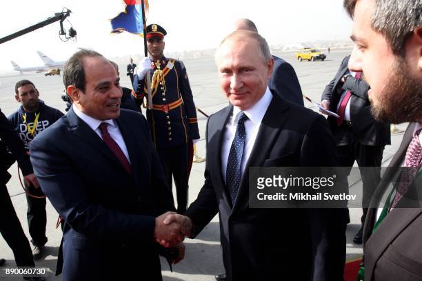 Russian President Vladimir Putin and Egyptian President Abdel Fattah el-Sisi attend a welcoming ceremony at the airport on December 11, 2017 in...