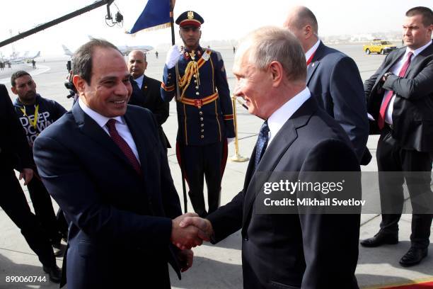 Russian President Vladimir Putin and Egyptian President Abdel Fattah el-Sisi attend a welcoming ceremony at the airport on December 11, 2017 in...