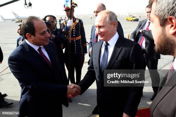 Russian President Vladimir Putin and Egyptian President Abdel Fattah el-Sisi attend a welcoming ceremony at the airport on December 11, 2017 in...