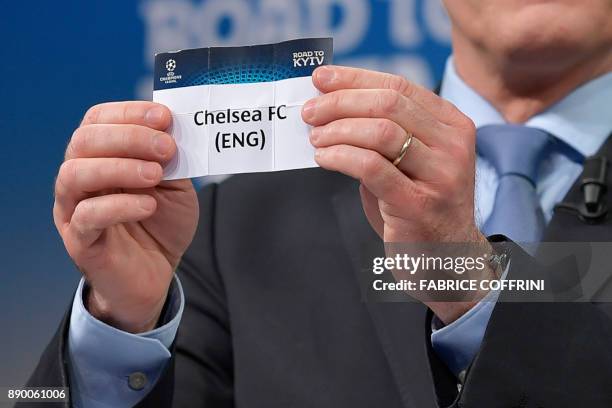 Director of competitions Giorgio Marchetti shows the slip of Chelsea FC during the draw for the round of 16 of the UEFA Champions League football...