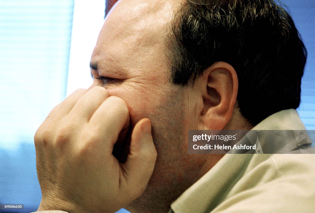 Man with hand on his cheek