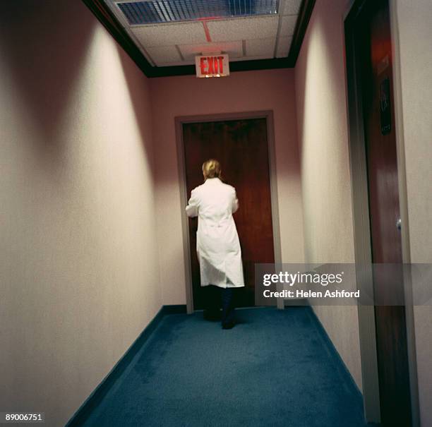 medical professional in a hallway - doctor leaving stock pictures, royalty-free photos & images