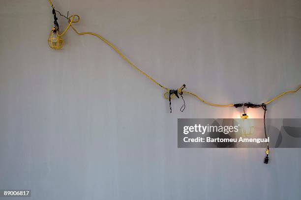utility lamp hanging on wall - foco de luz fotografías e imágenes de stock