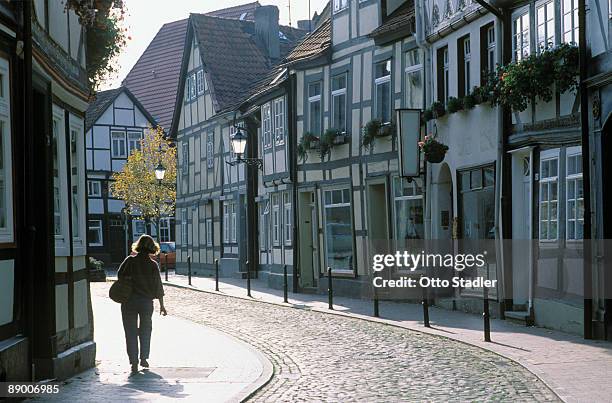 pedestrian walking on cobblestone street, germany - weserbergland stock-fotos und bilder