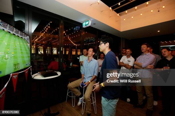 Team Australia captain Simon Katich watches his team mate compete in a FIFA video game round during the Yorkshire Tea's Big Cricket Quiz at Prince...