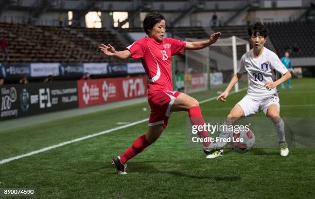 Phyong Sim of DPR Korea and Kim Hyeri of South Korea in action during the EAFF E-1 Women's Football Championship between North Korea and South Korea...