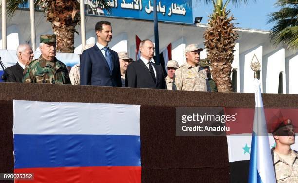 Russian President Vladimir Putin accompanied by President of Syria, Bashar al-Assad visits the Hmeymim base in Syria's Latakia on December 11, 2017.