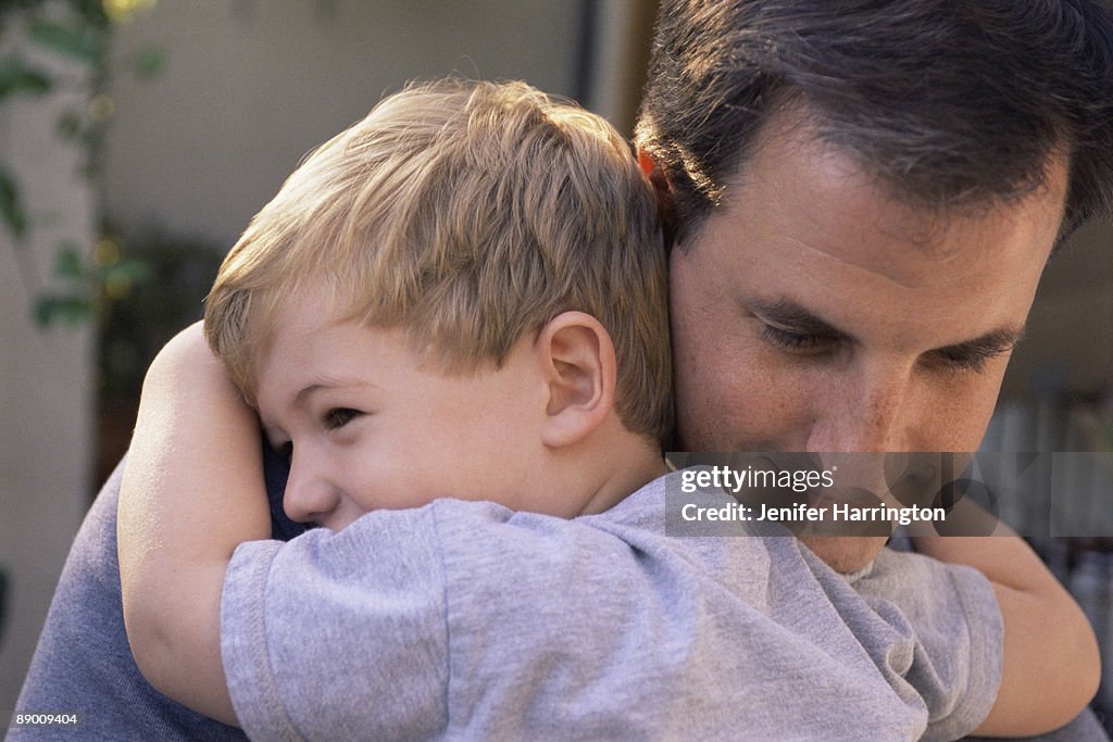 Father and son embracing