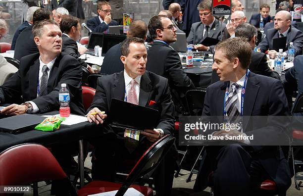 Detroit Red Wings Scout Ari Vouri looks on as Vice President Christopher Ilitch looks to Director of Hockey Administration Ryan Martin of the Detroit...