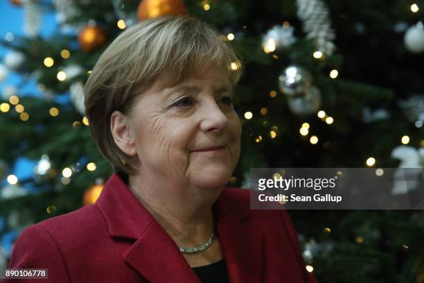German Chancellor and leader of the German Christian Democrats Angela Merkel walks past a Christmas tree as she departs following a press conference...