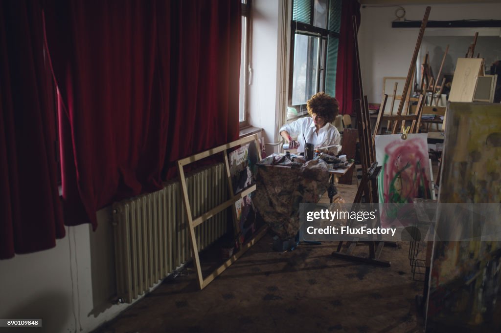 Woman artist working at her studio