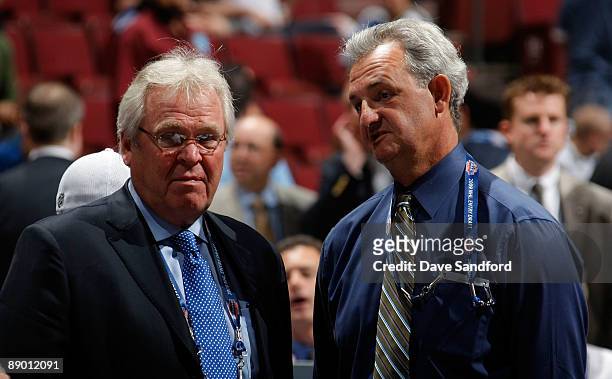 General Manager Glen Sather of the New York Rangers and General Manager Darryl Sutter of the Calgary Flames look on from the draft floor during the...
