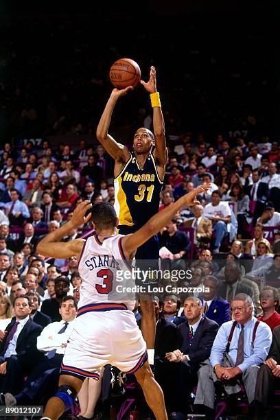 Reggie Miller of the Indiana Pacers shoots a jump shot against John Starks of the New York Knicks in Game Five of the Eastern Conference Semifinals...