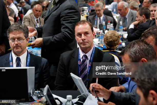 General Manager Joe Nieuwendyk of the Dallas Stars looks on from the Stars draft table during the second day of the 2009 NHL Entry Draft at the Bell...