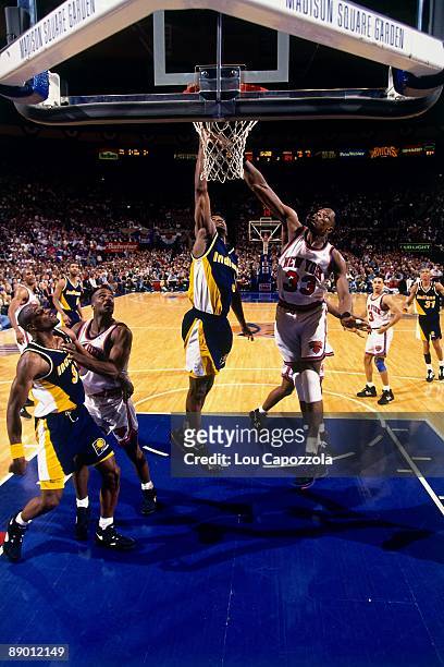 Haywoode Workman of the Indiana Pacers shoots a layup against Patrick Ewing of the New York Knicks in Game Five of the Eastern Conference Semifinals...