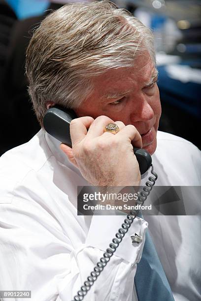 General Manager Brian Burke of the Toronto Maple Leafs listens on the phone at the Leafs draft table during the second day of the 2009 NHL Entry...