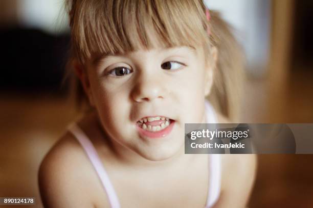 cute toddler girl with crossed eyes - cross eyed stock pictures, royalty-free photos & images