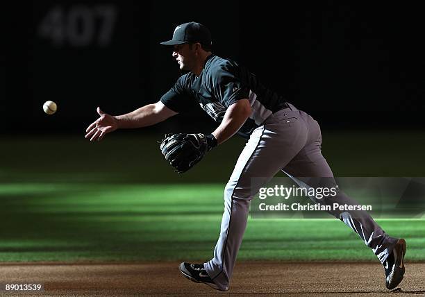 Infielder Dan Uggla of the Florida Marlins warms up before the major league baseball game against the Arizona Diamondbacks at Chase Field on July 10,...