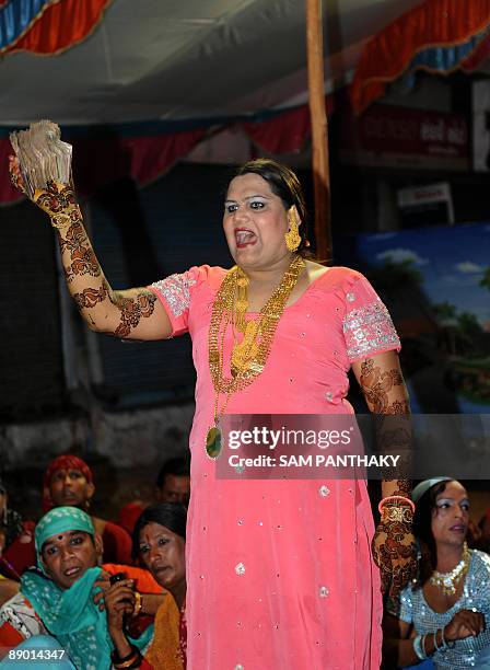 President of Gujarat State Kinnar Association Sonia De displays Indian currency received for Eunuchs during their wedding reception in Ahmedabad on...