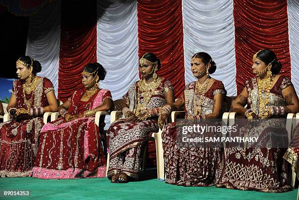Indian eunuchs sit on a dias during their wedding reception in Ahmedabad on July 12, 2009. In the presence of some one hundred eunuchs of the...