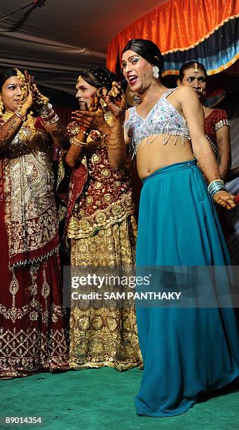Indian eunuchs dance during their wedding reception in Ahmedabad on July 12, 2009. In the presence of some one hundred eunuchs of the association a...