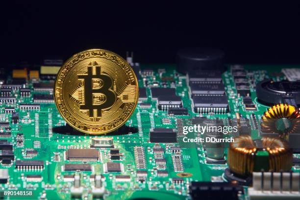 bitcoin cryptocurrency on a circuit board - circuit bank of brazil stock pictures, royalty-free photos & images