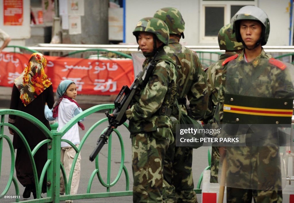 Chinese paramilitary policemen stand gua