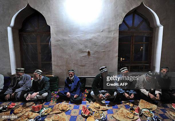 Tajiks have a lunch after praying in village Garm on July 12, 2009. A secretive military operation has raised fears that Islamist fighters fleeing...
