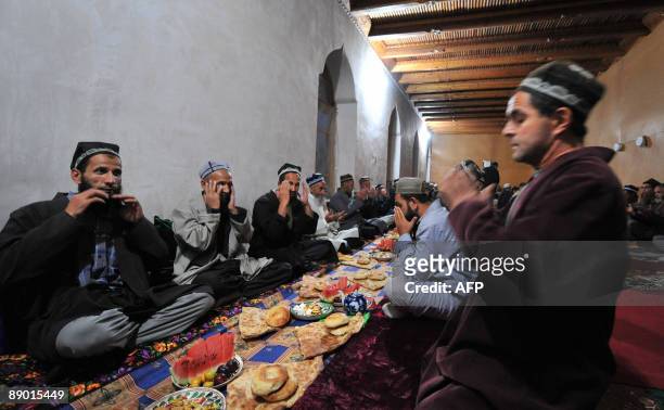 Tajiks pray before the evening meal in the village of Garm, some 250km from Dushanbe, on July 12, 2009. A secretive military operation has raised...
