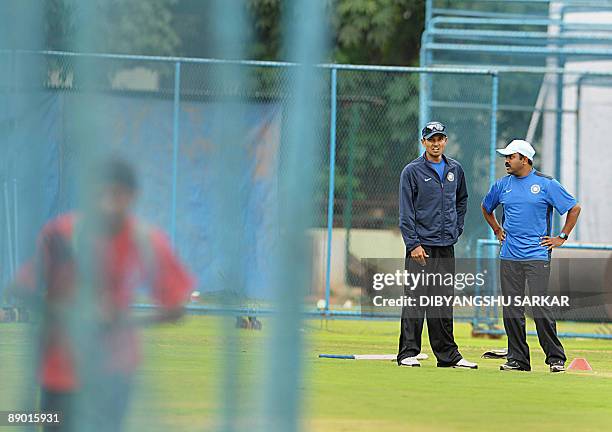 Indian cricketer S. Badrinath talks with coach Praveen Amre as he attends a camp at the National Cricket Academy in Bangalore on July 14, 2009. The...