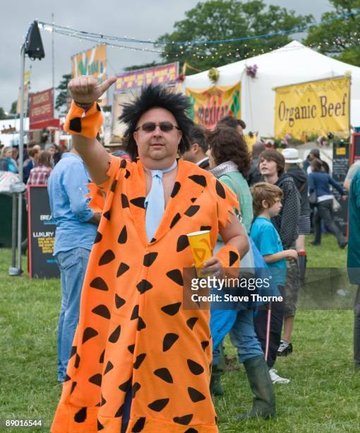 Fred Flintstone impersonator in the crowd on the first day of Cornbury Festival on July 11, 2009 in Cornbury Park, Charlbury, Oxfordshire, United...