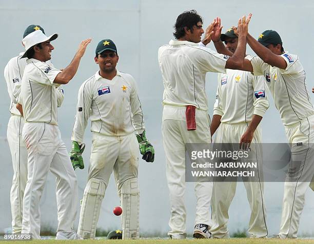 Pakistan cricketer Abdur Rauf celebrates with teammates the dismissal of Sri Lankan cricketer Malinda Warnapura during the third day of the second...