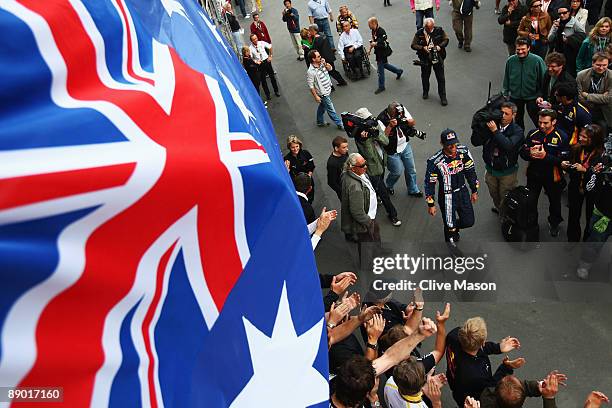 Mark Webber of Australia and Red Bull Racing celebrates with team mates in the paddock after winning the German Formula One Grand Prix at Nurburgring...