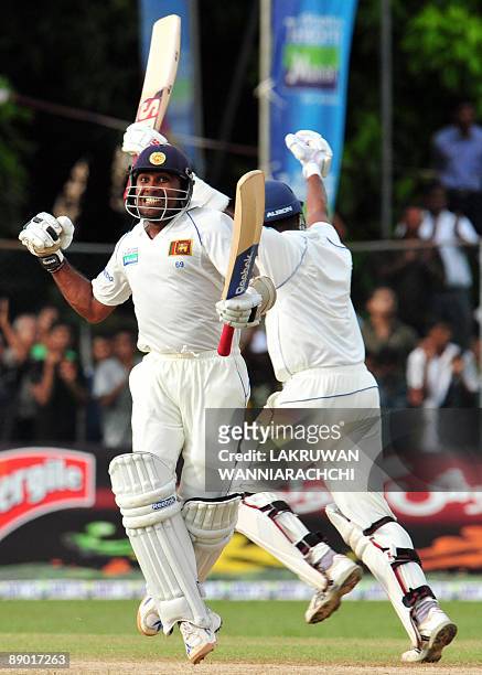 Sri Lankan cricketer Mahela Jayawardene and teammate Thilan Samaraweera celebrate their victory in the third day of the second Test match between...