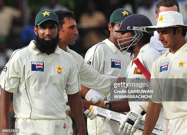 Pakistan cricket captain Younus Khan is congratulated by Sri Lankan cricketer Mahela Jayawardene at the conclusion of the third day of the second...