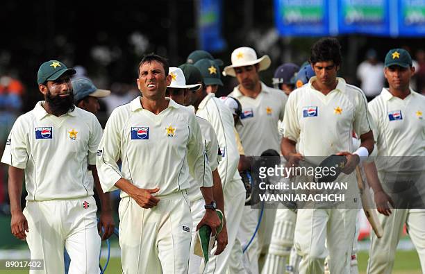 Pakistan cricketers, led by team captain Younus Khan , leave the ground following their defeat at the conclusion of the third day of the second Test...