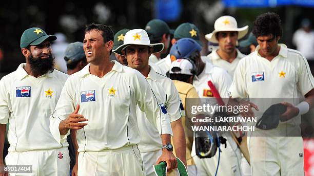 Pakistan cricketers, led by team captain Younus Khan , leave the ground following their defeat at the conclusion of the third day of the second Test...