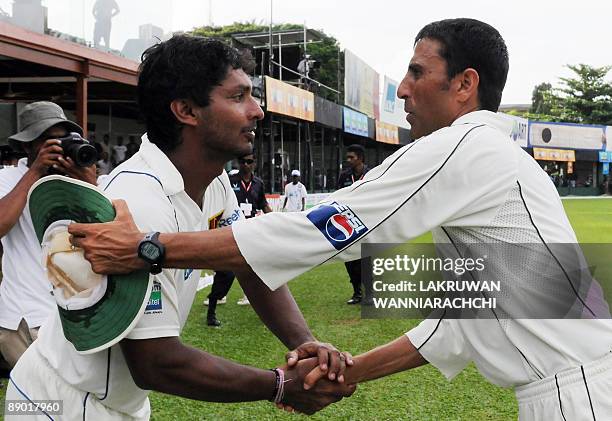 Pakistan cricket captain Younus Khan is congratulated by Sri Lankan cricket captain Kumar Sangakkara at the conclusion of the third day of the second...