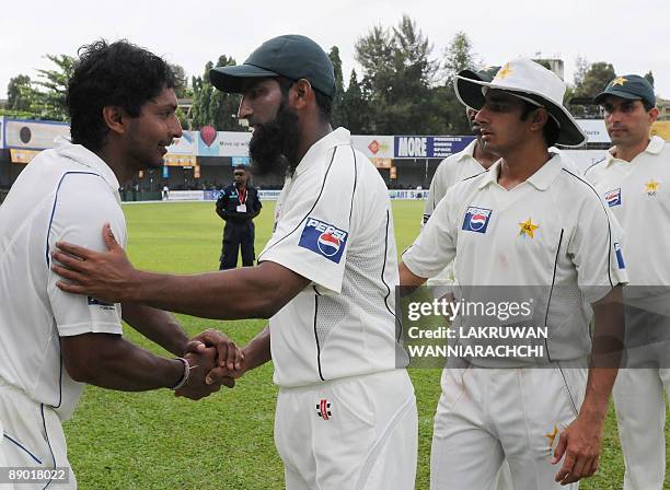 Pakistan cricketer Mohammad Yousuf congratulates Sri Lankan cricket captain Kumar Sangakkara at the conclusion of the third day of the second Test...