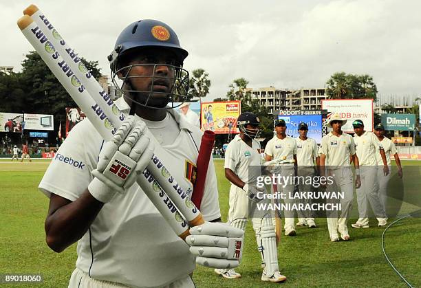 Sri Lankan cricketers Thilan Samaraweera and Mahela Jayawardene carry the stumps in triumph at the conclusion of the third day of the second Test...