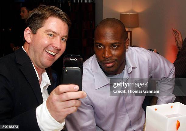 Palm representative Tim Petitt demonstrates the palm Pre for St. Louis Rams Will Witherspoon at the Palm Gift Lounge at the Ryan Howard All Star Bash...