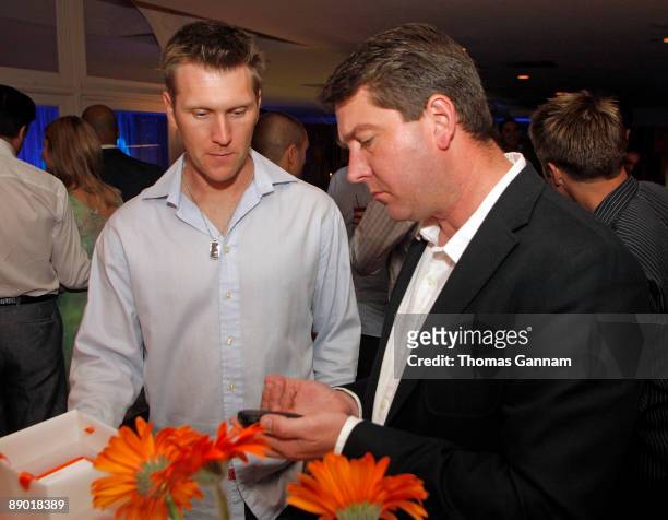 Palm representative Tim Petitt, right, demonstrates the palm Pre to Boston Red Sox All-Star left-fielder Jason Bay at the Palm Gift Lounge at the...