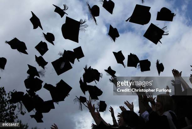 Students throw their mortarboards in the air during their graduation photograph at the University of Birmingham degree congregations on July 14, 2009...