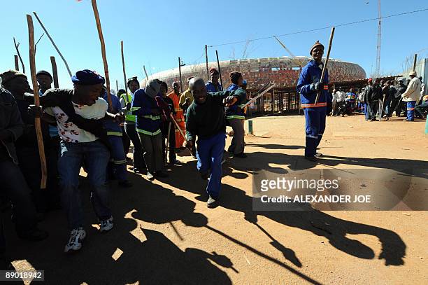 Striking South African construction workers at City Stadium in Soweto demonstrate on July 14, 2009. Protesting workers marched around the stadium,...