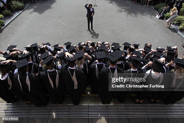 The photographer instructs students to adjust their mortartboards at the University of Birmingham as they graduate on July 14, 2009 in Birmingham,...