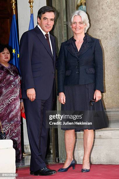 French Prime Minister Francois Fillon and his wife Penelope arrive at the garden party to celebrate Bastille Day at Elysee Palace on July 14, 2009 in...