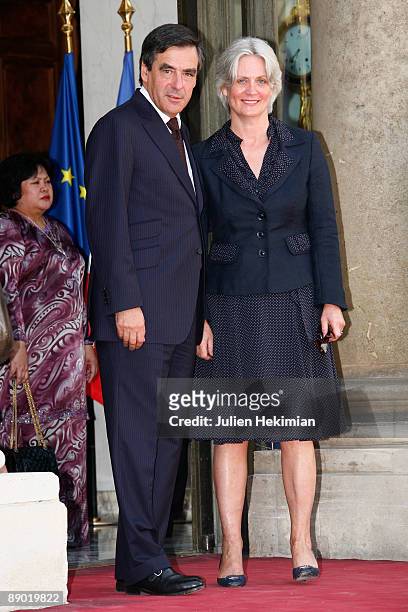 French Prime Minister Francois Fillon and his wife Penelope arrive at the garden party to celebrate Bastille Day at Elysee Palace on July 14, 2009 in...