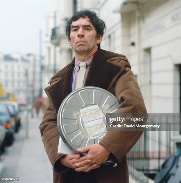 English film producer Kenith Trodd with a can of film by writer Dennis Potter, 20th November 2003. Trodd produced most of Potter's television dramas.