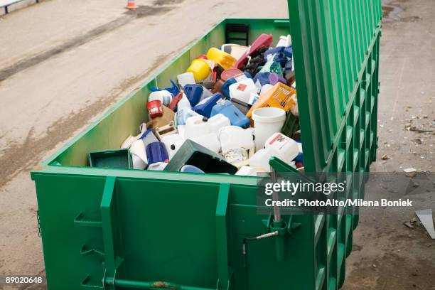 large recycling bin full of discarded plastic containers - afvalcontainer stockfoto's en -beelden